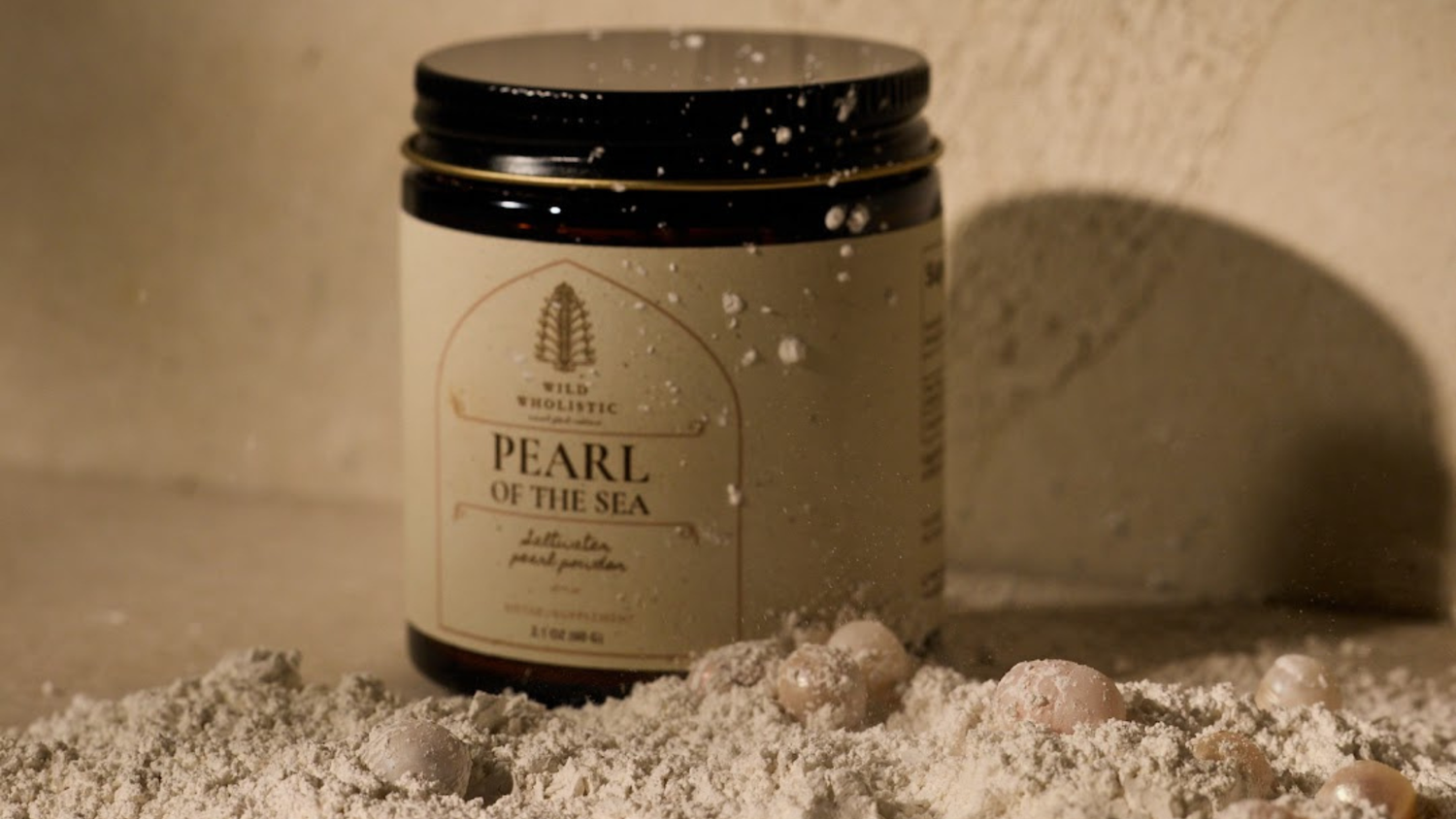 Jar of 'Pearl of the Sea' product on a textured surface with a neutral background