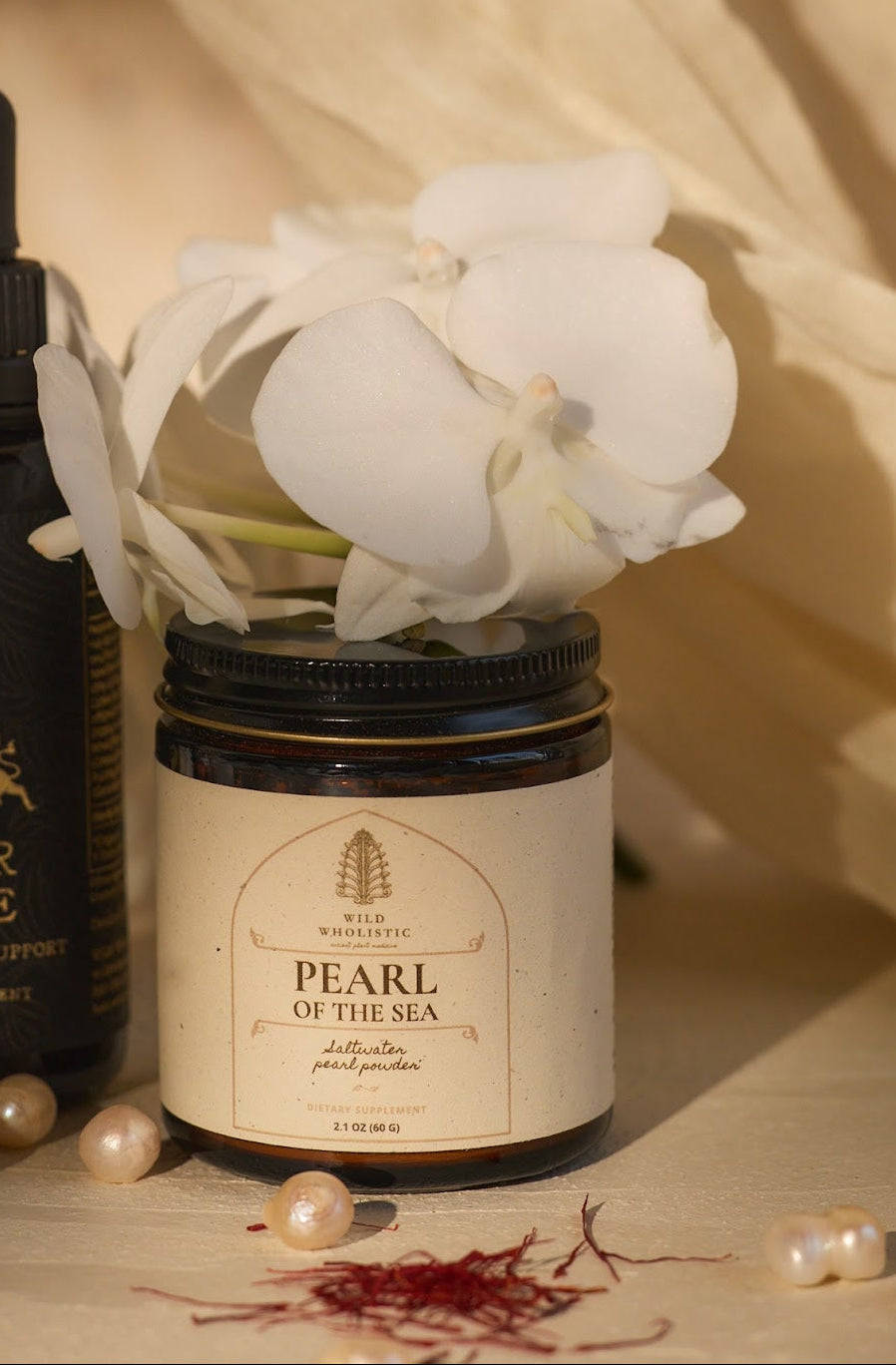 Jar of 'Pearl of the Sea' with white flowers and pearls.