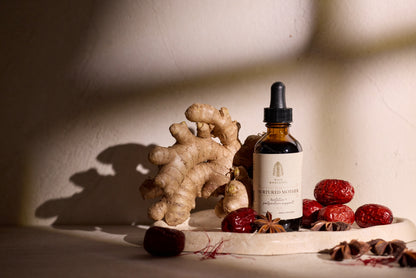 Nurtured Mother postpartum herbal tincture and dried red dates with saffron threads and ginger root.