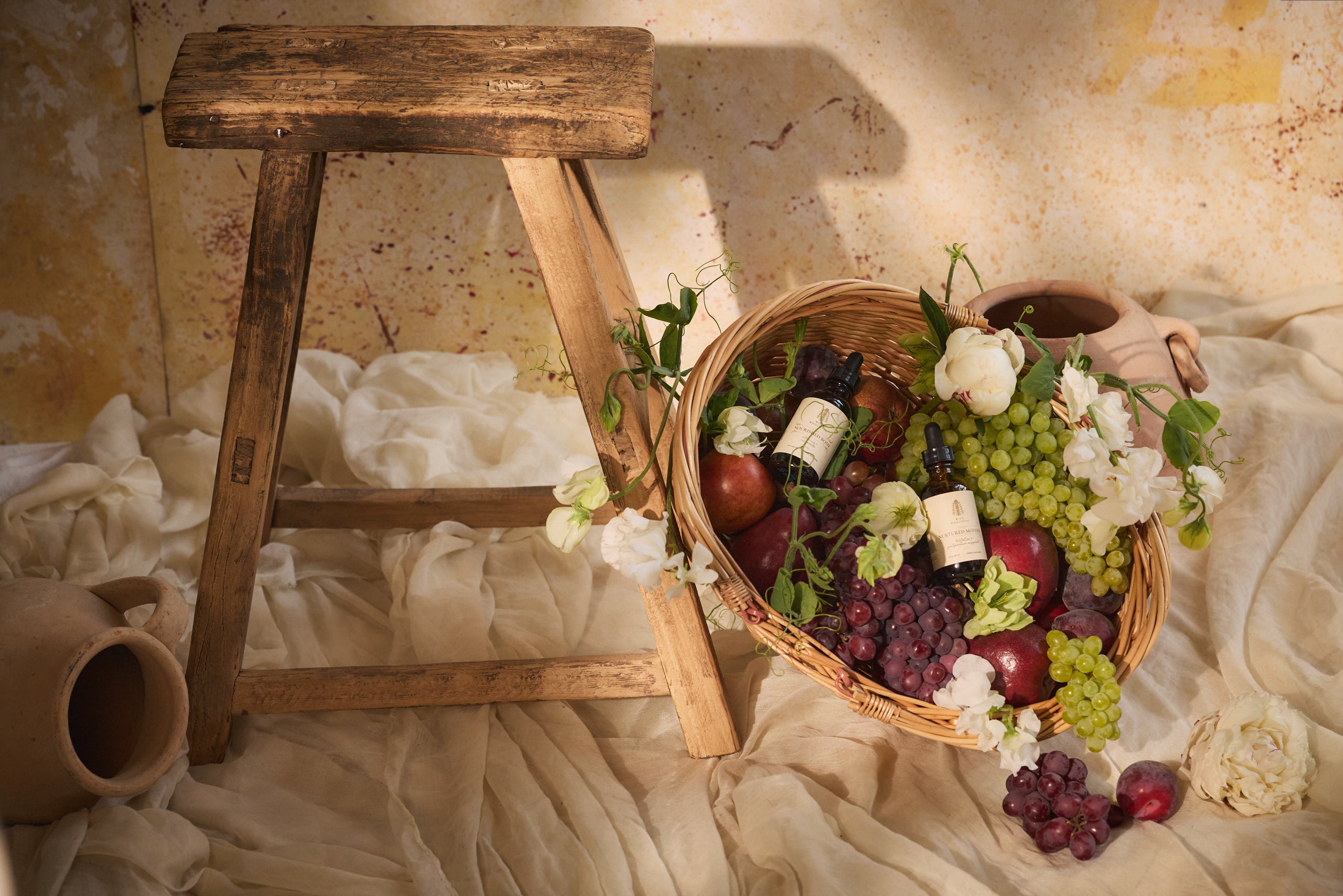 Wicker basket with fruits and Wild Wholistic products.